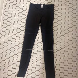 Ivivva by Lululemon black leggings with mesh reflective design.